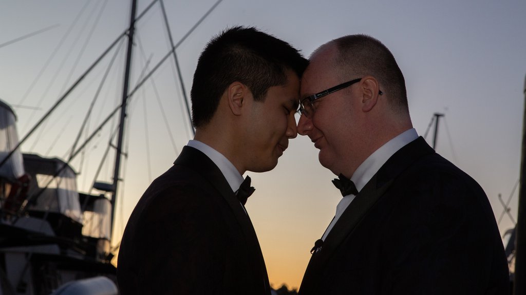 The couple shares a moment as the sun sets at the docks