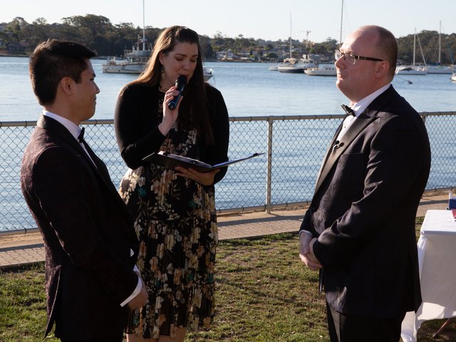 Suzie performs the celebrant's role as Rob and Minh face one another