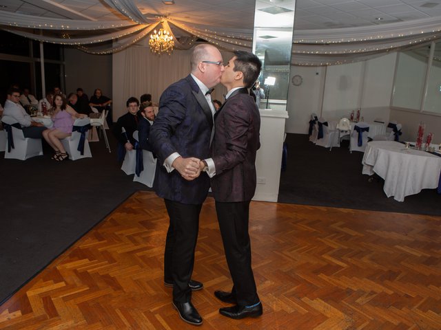 The couple closes their first dance with a kiss