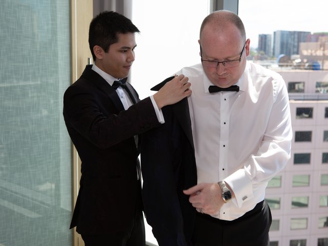 Minh helps Rob into his suit